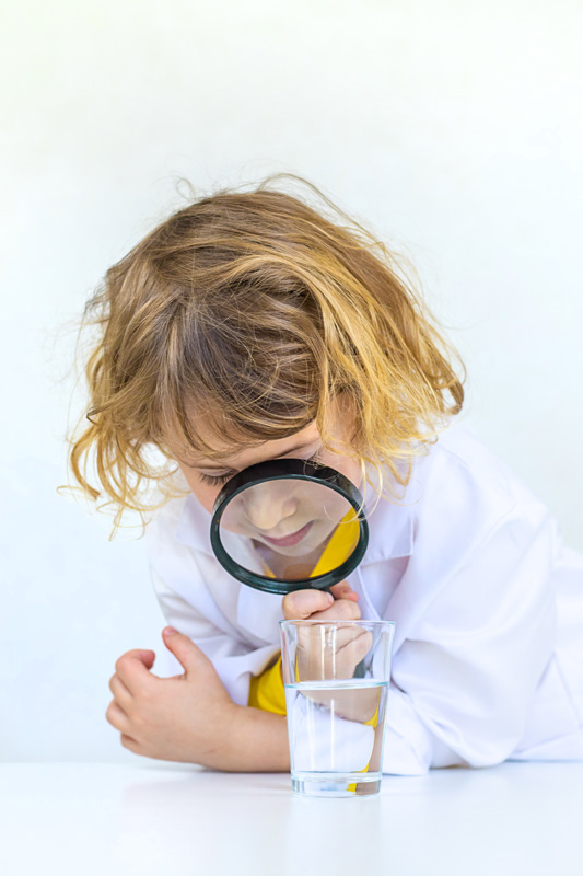 girl learning with magnifying glass and glass of w 2026 03 20 03 55 12 utc