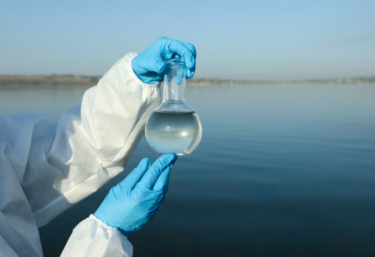 scientist with florence flask taking sample from r 2026 01 06 16 26 27 utc